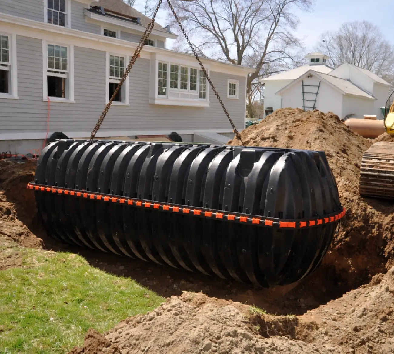 A newly installed septic system with concrete tank set in an excavated yard